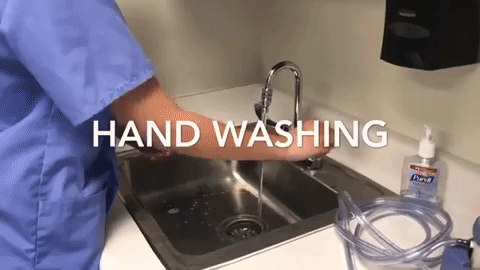 An animated gif of a tech in scrubs washing their hands