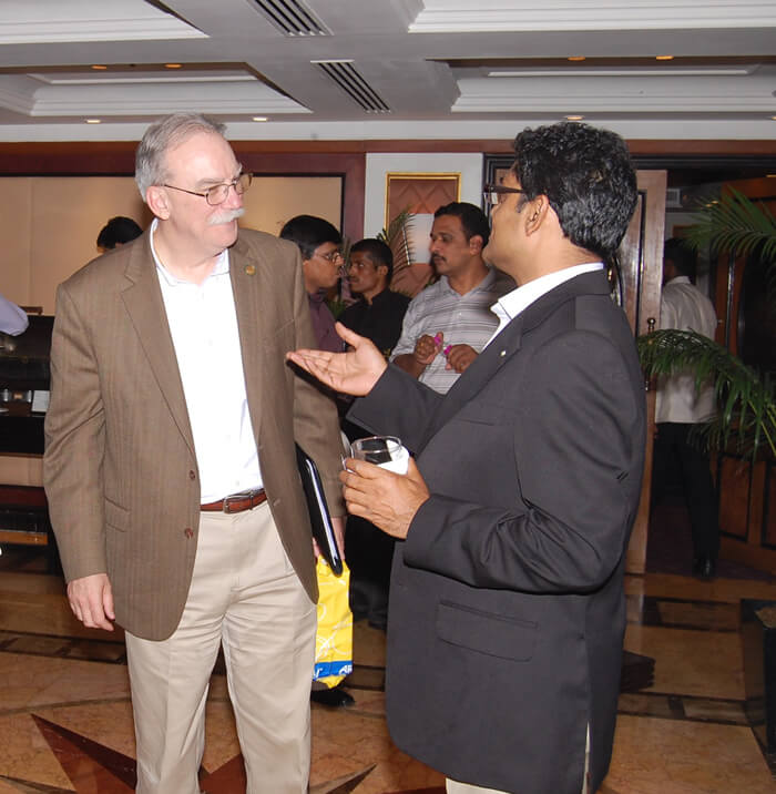 Amit Sharma conversing with Richard Johnson at a conference
