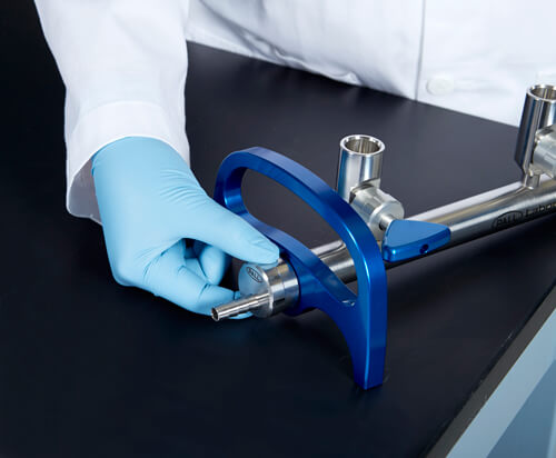 A hand placing a newly designed laboratory manifold